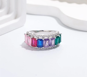 Macro view of wide silver band featuring colorful rectangular gems and zircon borders