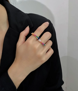 Close-up of dual-finger ring with rainbow marquise crystals on a gold-plated band