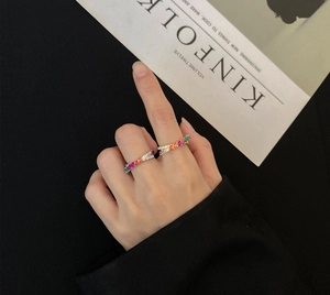 Detailed shot of gold and silver twisted rings set with colorful marquise gemstones
