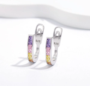 Macro shot of 925 sterling silver U-shaped earrings with colorful square zircons
