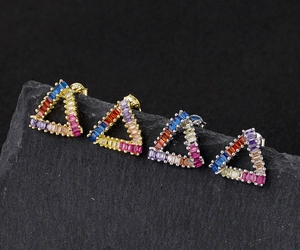 Macro shot of 925 silver triangle studs with colorful rectangular zirconia gemstones