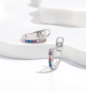 Macro shot of 925 silver U-shaped earrings with rainbow zircons and hallmark detail