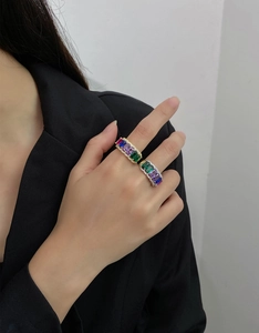 Detail of wide S925 silver rings with colorful rectangular stones on female hand