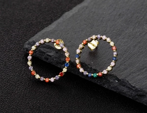 Close-up of S925 hallmark on gold plated stud earrings with multi-color zircon stones