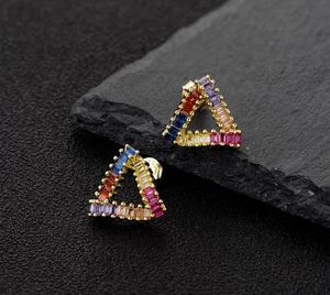 Macro view of triangle sterling silver stud earrings with colorful zircon inlay and S925 stamp