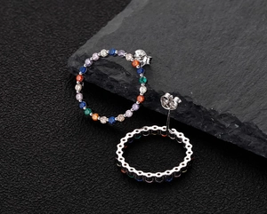 Detail of 925 silver hoop earrings with multicolored rainbow cubic zirconia inlay