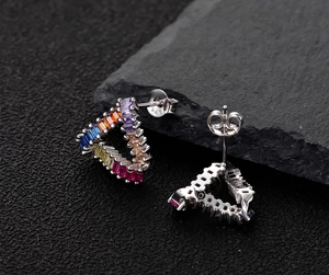 Detailed close-up of S925 sterling silver stamp and rainbow gemstone triangle earrings