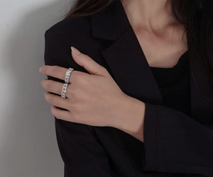 Close-up of stacked S925 silver rings with pavé zircon stones and a central round gemstone