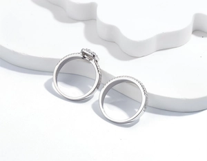 Macro shot of 925 silver luxury ring set with radiant cut stone and pavé diamond band