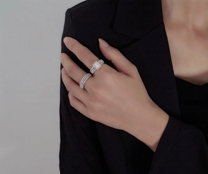 Close-up of S925 silver stacked rings set featuring an emerald cut stone and pavé band
