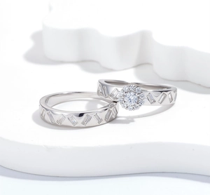 Macro detail of S925 sterling silver ring set featuring halo set stones on a white podium