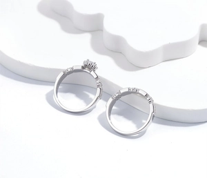Macro detail of S925 sterling silver stacked rings with 6-prong solitaire and pavé band
