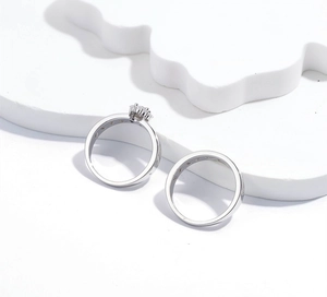 Detail view of S925 silver ring set with round halo cubic zirconia on white wave stand