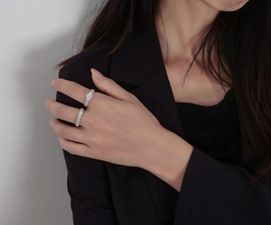 Detail of S925 sterling silver stacked rings set with sparkling pave-set rectangle diamonds