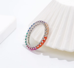 Macro view of rainbow zircon eternity ring with silver milgrain edge detail