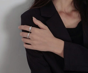 Macro detail of S925 silver ring set featuring hammered texture and coin relief on hand