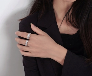 Detail of stacked S925 silver rings with baguette and round cut cubic zirconia on hand