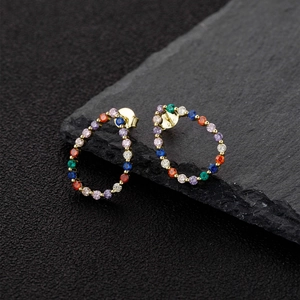 Teardrop S925 silver hoop earrings with vibrant multi-color zircons on dark rock