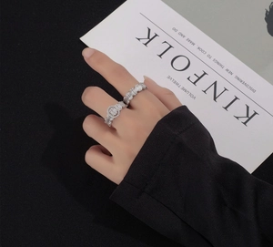 Close-up of S925 sterling silver stacked rings with baguette and round cut zircons