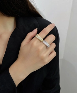 Close-up of wide multi-row micro-pave cubic zirconia rings in 18k gold and silver plating