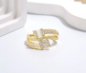 Macro shot of gold ring with baguette-cut and round-cut cubic zirconia in a wrap design