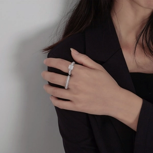 Lace patterned S925 silver ring set with rectangle crystal on a hand in black suit