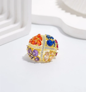 Macro view of colorful spherical ring with multi-color gems and 18k gold plating