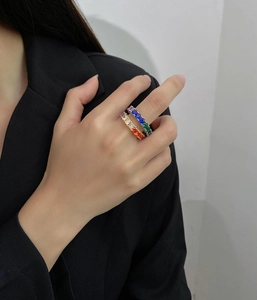 Close-up of vibrant rainbow cubic zirconia eternity rings in gold and silver settings