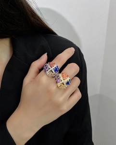 Macro detail of 925 silver and 18k gold rings with colorful gemstones in spherical design