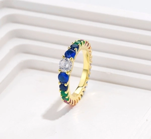 Detailed macro of S925 silver ring with rainbow gemstones on gold metal base