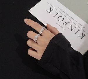 Detail shot of a layered S925 silver snowflake ring set with zircon on a model's hand
