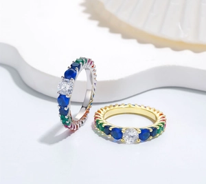 Close-up of rainbow multi-color cubic zirconia stones on silver and gold plated rings