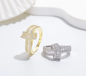 Detailed view of crisscross rings with gold plating and micro-pave cubic zirconia stones