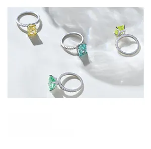 Macro shot of silver rings with vibrant radiant cut gems and shimmering pave diamonds