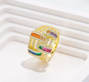 Macro shot of 18K gold-plated wide ring with woven texture and colorful pavé cubic zirconia