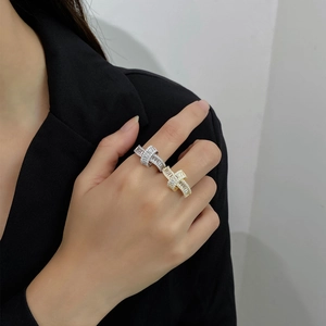 Detail of 925 silver and 18k gold rings with pavé cubic zirconia on female hand