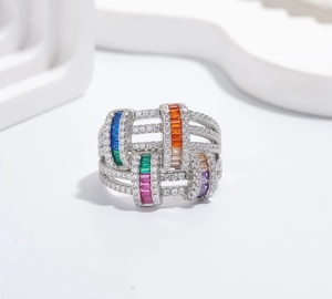 Detailed macro of multi-layer silver ring with colorful baguette gems and pavé zircons