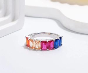 Detail of 925 sterling silver stamp and colorful rectangular cut stones on gold ring