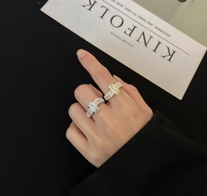Detail of twisted 925 silver rings with baguette and round cut pavé cubic zirconia