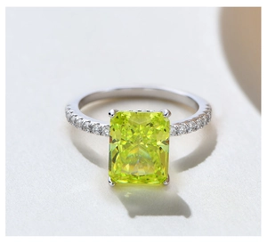 Macro shot of 8x10mm radiant cut yellow gemstone ring with silver band and micro pave diamonds