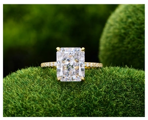 Vue macro détaillée d'une bague diamant radiant sur un fond de mousse verte naturelle