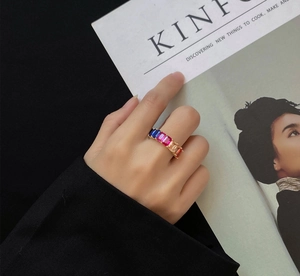 Detailed view of rainbow gemstone ring with 18k gold plating on a fashion model