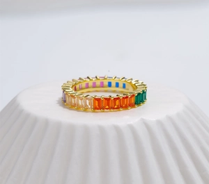 Macro view of gold S925 silver eternity ring with rainbow baguette-cut cubic zirconia