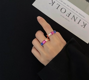Detail of 18k gold plated silver ring featuring channel-set rainbow colored crystals