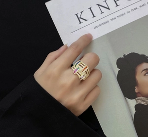 Detail of wide 18k gold plated ring featuring rainbow crystals and woven grid texture