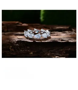 Macro shot of 925 silver eternity ring with pear-cut high carbon diamonds on wood