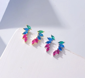 Detailed macro view of S925 sterling silver leaf studs with marquise colorful zircons