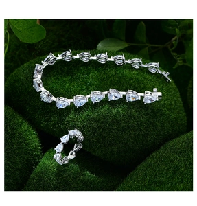 Macro detail of pear-cut high carbon diamond bracelet and ring set in 925 silver