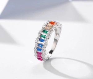 Macro shot of S925 silver mesh ring featuring colorful baguette-cut rainbow gems