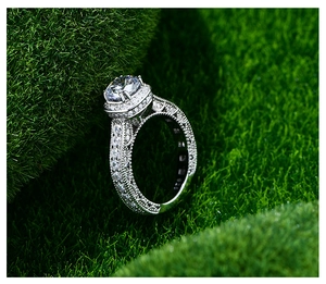 Macro side view of S925 sterling silver ring with 7mm round diamond on green moss